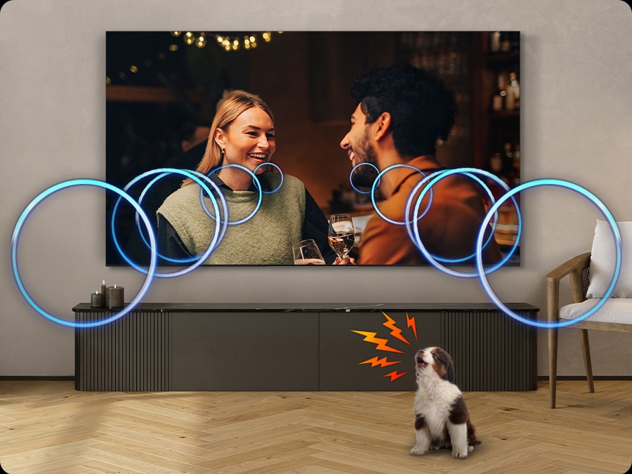 The volume of a TV dialogue increases to cover the sound of a puppy barking in a living room.