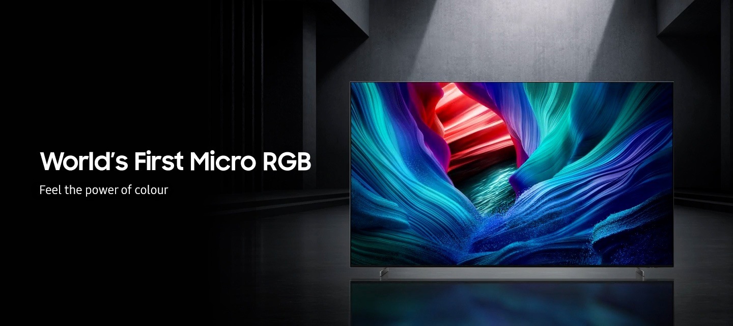 A Micro RGB TV in a gray room plays a scene with abstract colors. A caption reads 'World's 'First Micro RGB, Feel the power of color'.