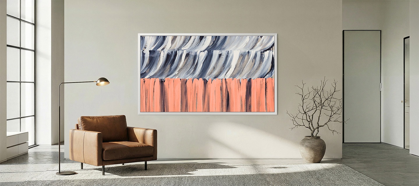 Minimalist living room with large window, leather armchair, and floor lamp, featuring The Frame TV mounted flush to the wall displaying abstract artwork, blending seamlessly like a framed painting.