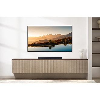 B400F soundbar placed beneath a TV in a living room.