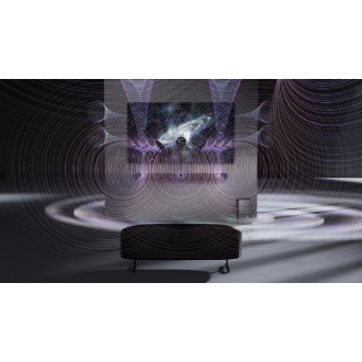 Q600F is mounted on the wall beneath a TV in a black and white room. Diverging sound waves are visible, and the TV displays an abstract black wavy background.