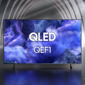 Samsung QLED QEF1 TV in a black and white indoor space displays a colorful scene of an otherworldly landscape.