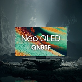Samsung Neo QLED QN85F TV in a black and white underground space displays a colorful scene of an otherworldly landscape.
