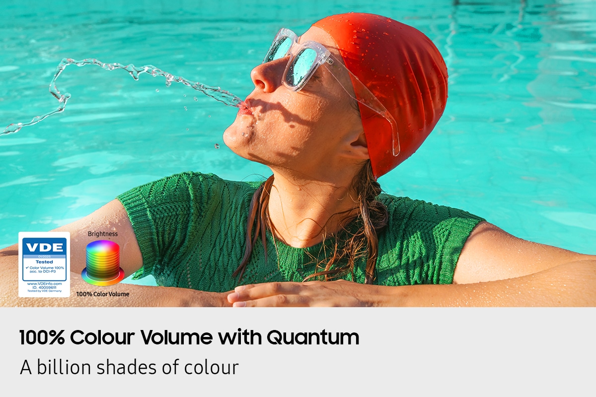 A woman is spitting out water in the pool. All the colors in the image become vivid as the brightness level increases. VDE tested logo is on display.