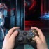 A scene in a game is on display while a person plays with the gaming console. 