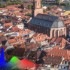A scene of a city is split in two. The left side is displayed with conventional TV while the right side is displayed with Crystal UHD.