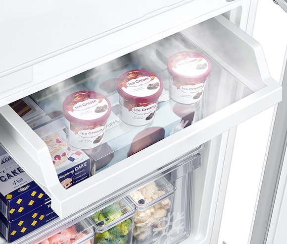 Three cans of ice cream are neatly stored on the slide Easy Slide Shelf. Cold air keep ice cream frozen.
