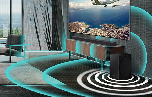 Closeup of soundbar and subwoofer in living room are shown. A grid graphic covers the living room and thickly drawn sound wave graphics are shown beneath the subwoofer to illustrate that Auto EQ is automatically filling the room with powerful bass.