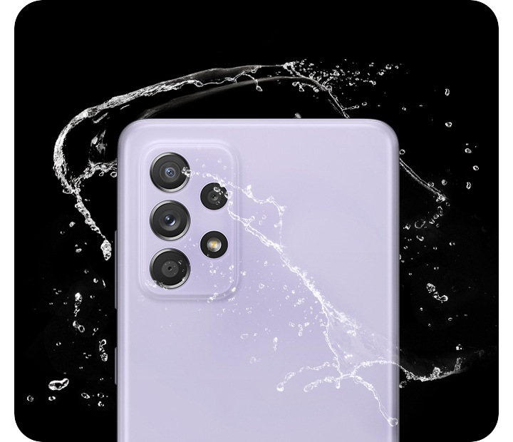 Galaxy A52s 5G in Awesome Violet, seen from the rear with water splashing around it.