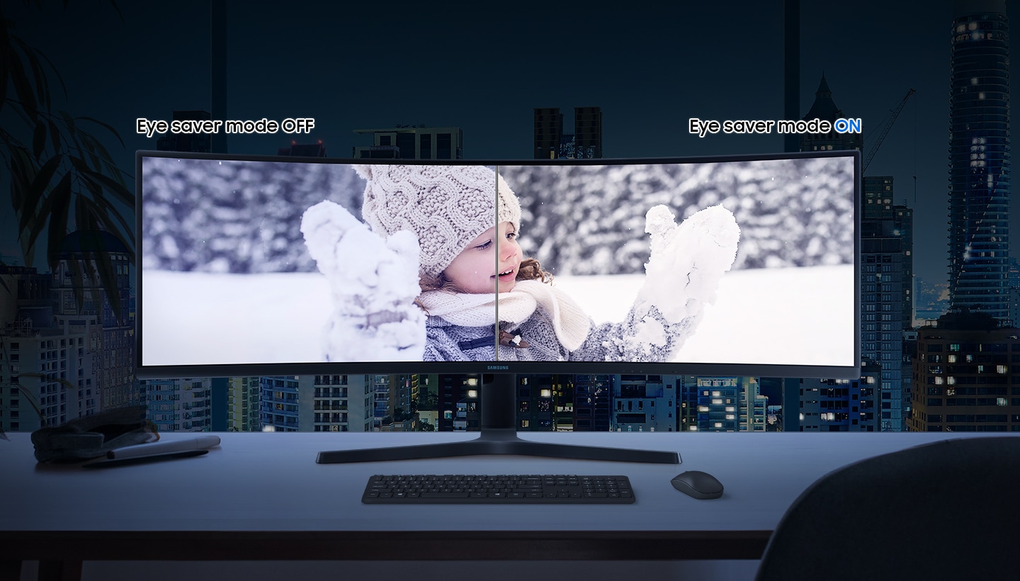 S9 shows a young girl in winter hat and gloves playing in the snow. Above the left corner of the monitor bezel is the text †Eye saver mode OFF' and above the right corner of the monitor bezel is the text †Eye saver mode ON'. The left side of the monitor is covered with light blue. The monitor is on a wooden desk with a keyboard and mouse in front in a dark room.