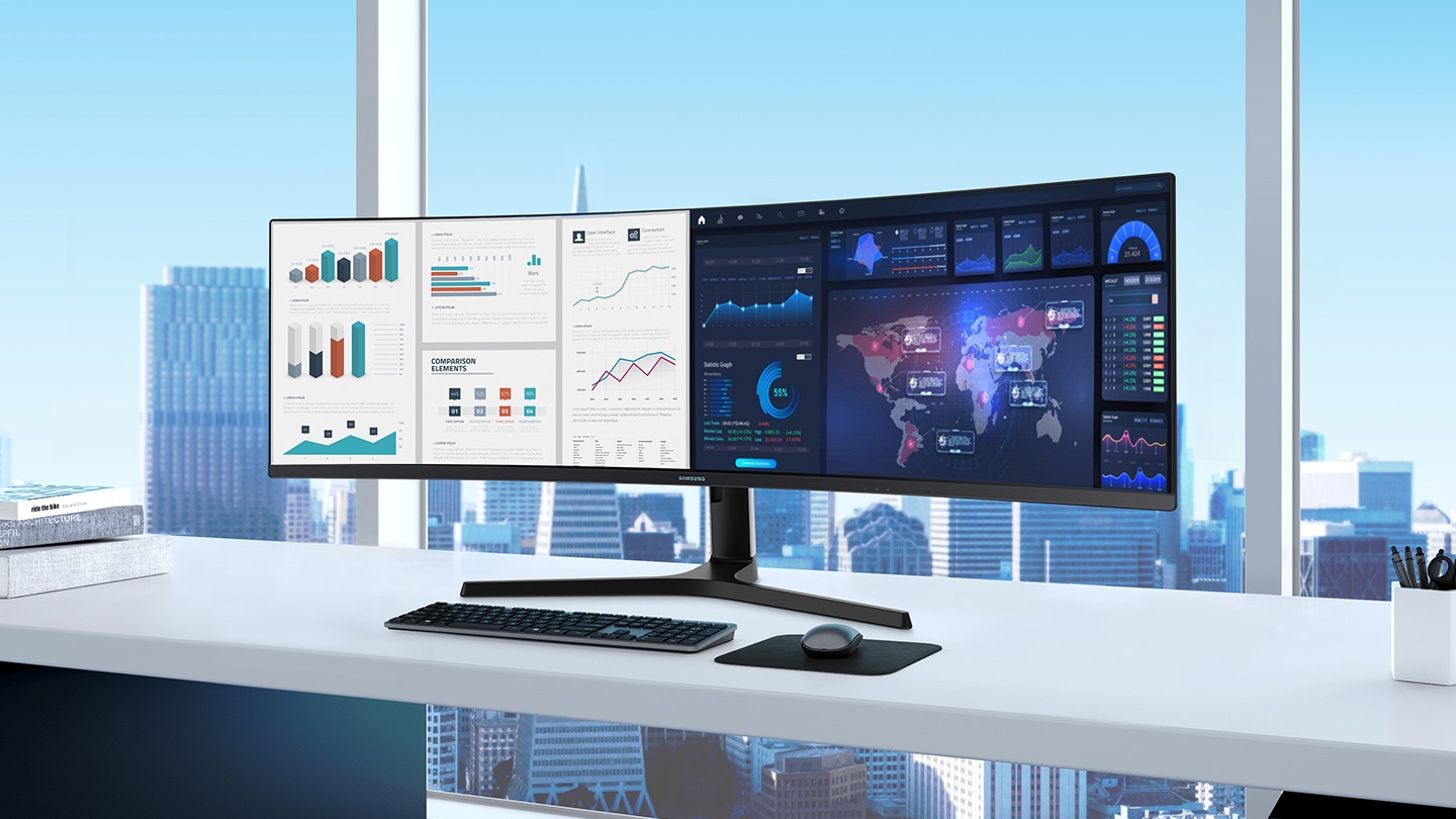 S9 is displaying a split screen in an office environment. The left side shows a collection of graphs, while the right side contains a digital map surrounded by a variety of graphs and data representations. In front of the monitor on a white desk is a black keyboard and mouse, on a black mouse mat.