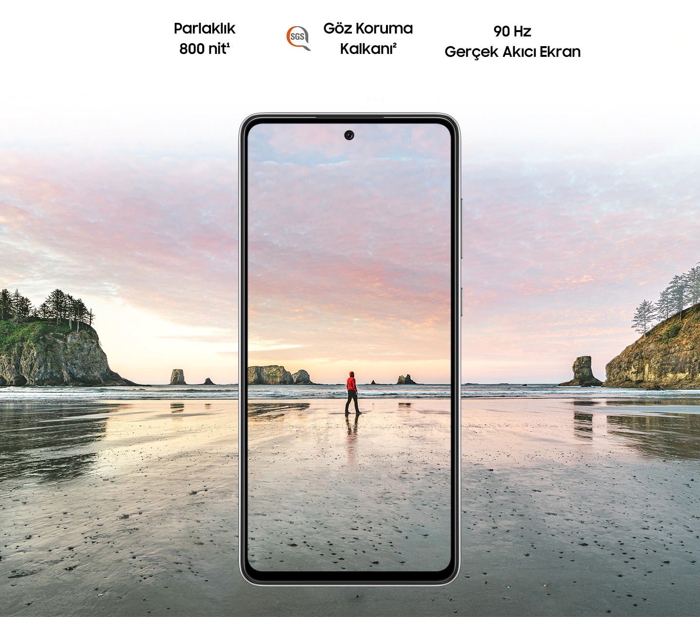 Galaxy A72 nden grlmekte. Gnbatmnda kumsalda ayakta duran bir adamn olduu sahnede gkyzndeki pembe ve mavi renkler ekrann snrlarnn dna tamakta. Metinde; Parlaklk 800 nit, SGS logosu ile Gz Koruma Kalkan ve Gerek Akc yazmakta.