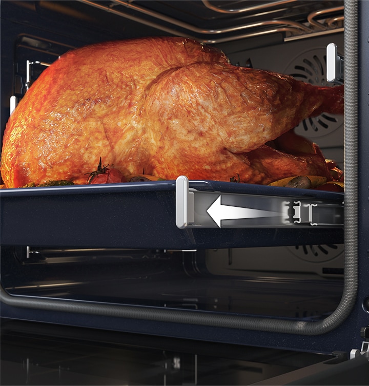 Shows a large roast turkey sliding out of the oven on the Telescopic Rail.