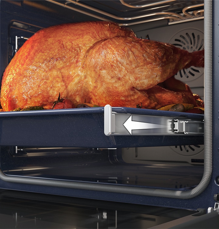 Shows a large roast turkey sliding out of the oven on the Telescopic Rail.