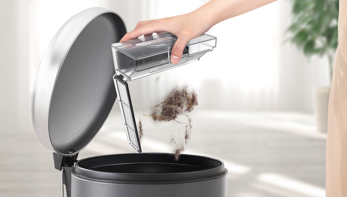 A person is emptying the Dustbin.
