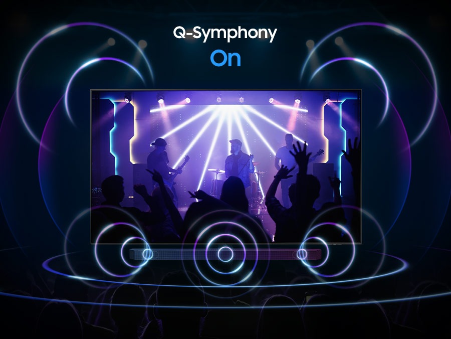 A Samsung TV plays a scene of a band performing, with a focus on the drummer. The TV emanates rings of sound in various sizes, which pulse energetically and travel in all directions to fill the space, indicating use of the Dolby Atmos feature.