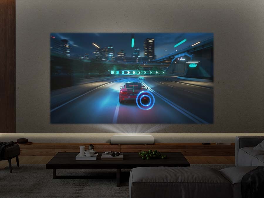 The Premiere projects a scene of a speeding racecar onto the wall. Rings of sound come out of the racecar's tires as it drives along the road.