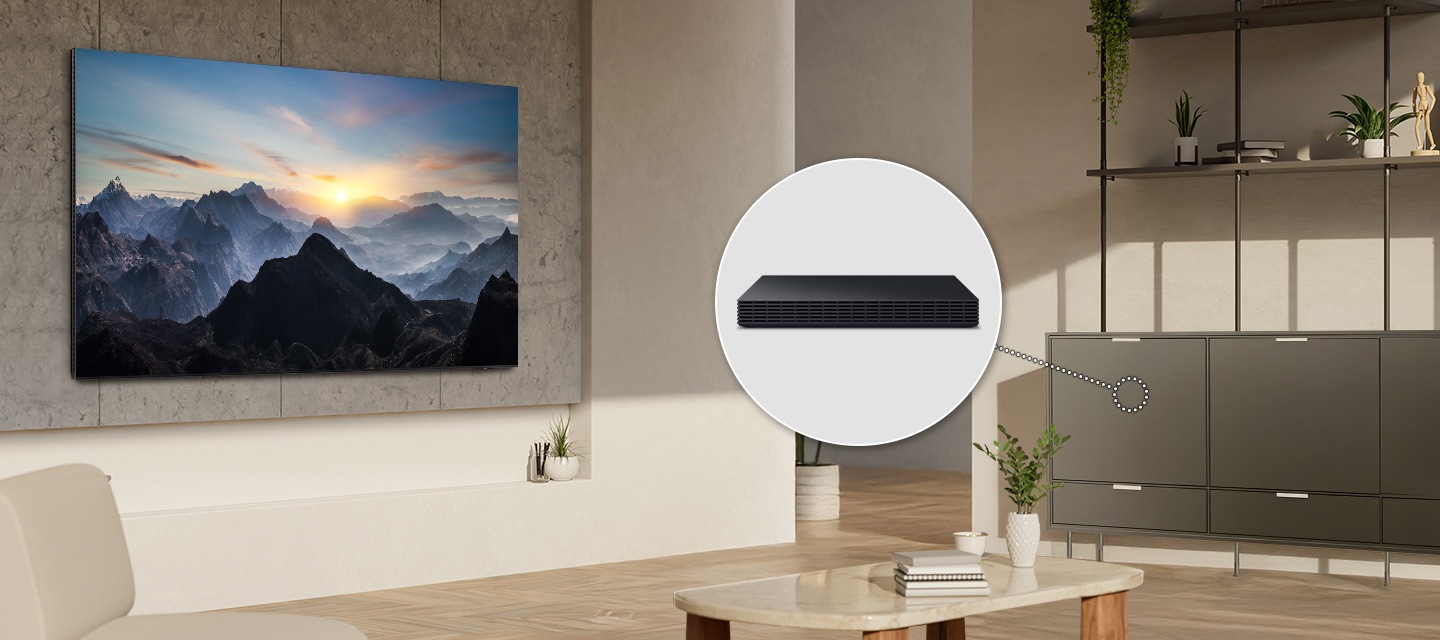 In a living room, a TV is installed cleanly on the wall with no wires. A Wireless One Connect box is hidden inside a cabinet.