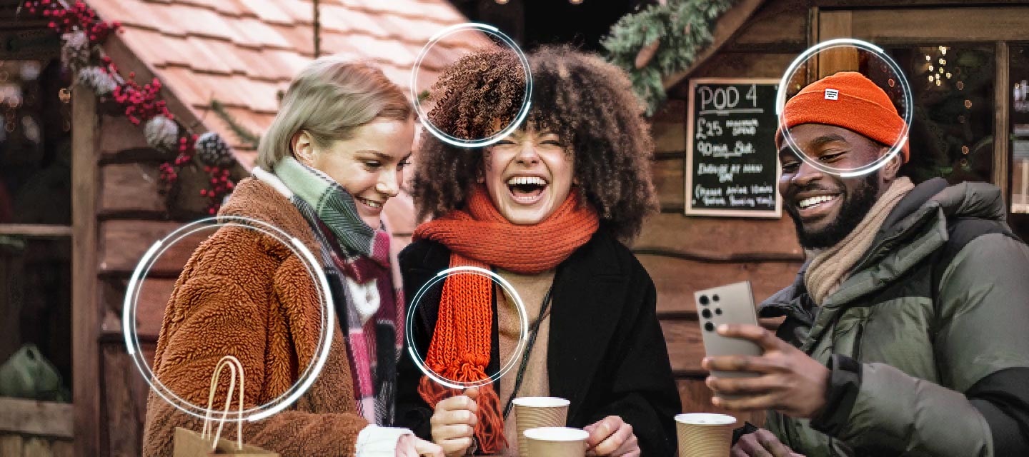 A slightly grainy scene of three people laughing outside. Samsung NQ8 AI Gen3 Processor appears on screen. It detects several different points on screen and clears them up. Then it clears up the entire screen, so the scene looks sharp and detailed.