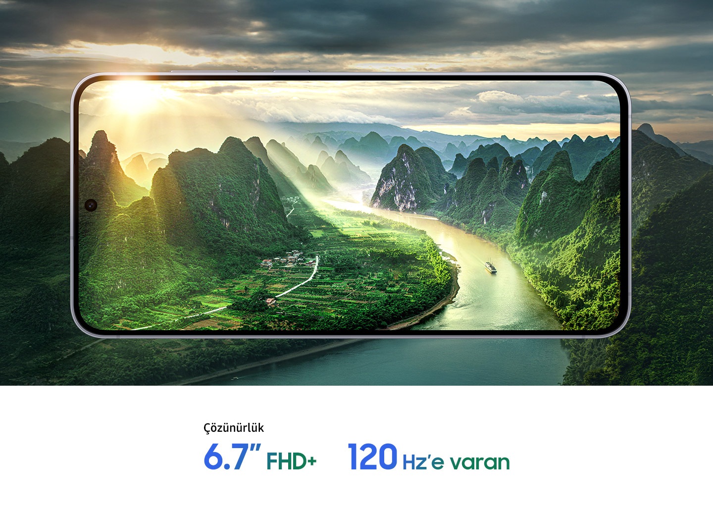 Akıllı telefon ekranında dağlar ve nehir görülen manzarada bulutların arasından güneş ışıkları süzülüyor. Alt kısımda “Çözünürlük: 6,7 inç FHD+” ve “Maks. 120 Hz” yazıyor.