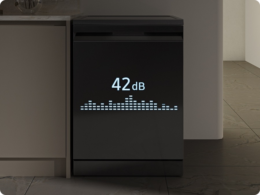 Shows the dishwasher in a modern kitchen working smoothly and quietly at night. Illuminated text on the front shows that it generates just 42dBA of sound. 