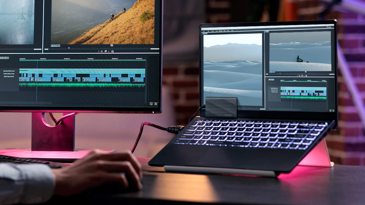 一個人在連接了他的筆記型電腦，並連接了 T9 設備後，正在編輯影片。