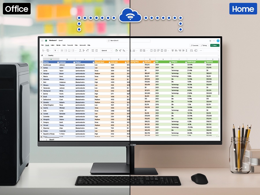 在辦公空間中的顯示器顯示一個包含大量資料的 Excel 檔案。這部顯示器透過 Wi-Fi 連接到家中的另一部顯示器，兩部顯示器都顯示相同的 Excel 檔案。