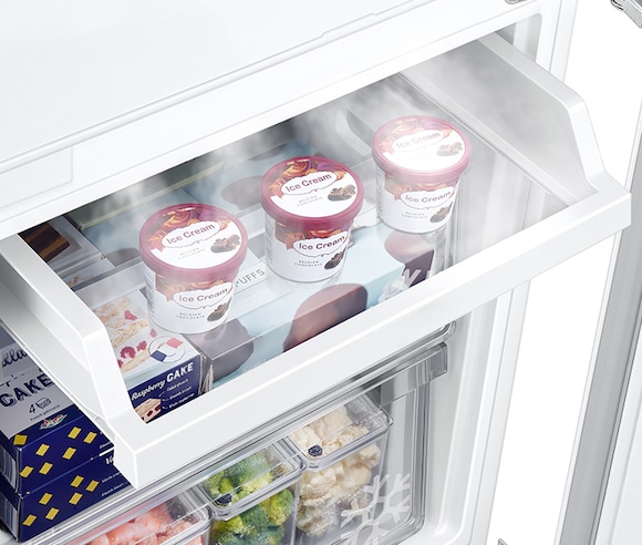 Three cans of ice cream are neatly stored on the slide Easy Slide Shelf. Cold air keep ice cream frozen.