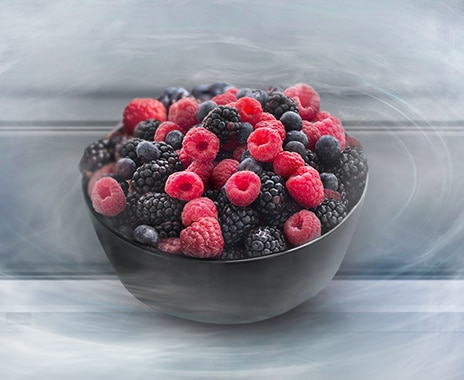 Cool, moist air surrounds a basket of frost-free raspberries.