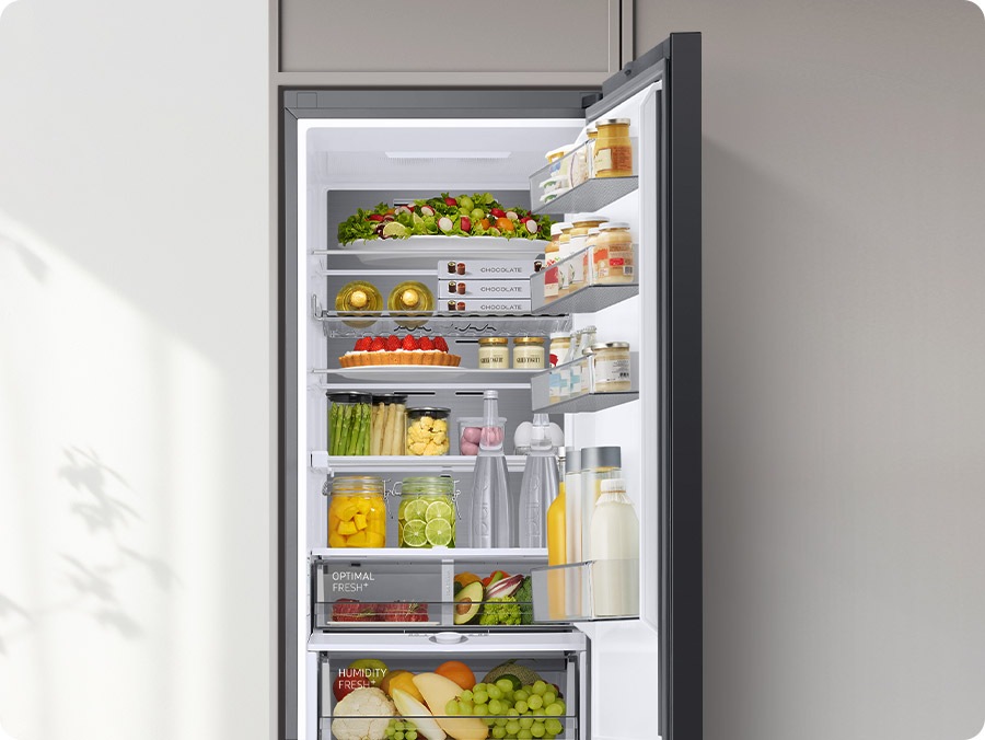 A Bespoke refrigerator filled with various foods is open. Cool air comes out through vents in each compartment to maintain the optimum temperature for the food to stay fresh.