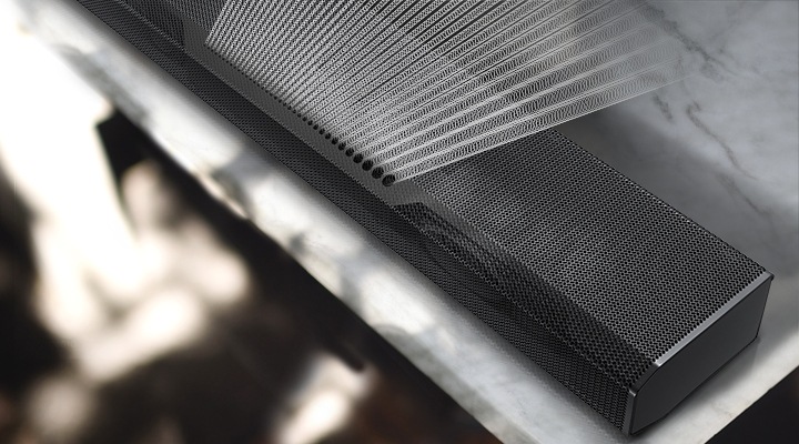 Precisely spaced soundwave graphics are coming out from the top of Q700A Soundbar, illustrating Samsung Acoustic Beam technology.