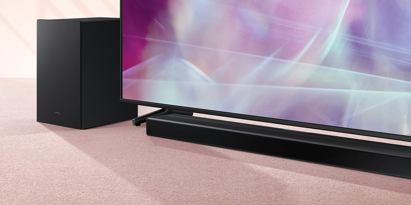 Samsung Q600A Soundbar and subwoofer are positioned next to QLED TV.