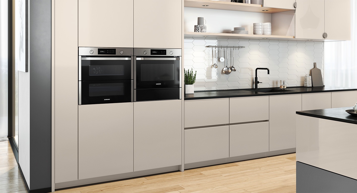 Shows the oven installed in a kitchen, with two independent cooking zones and a hinged door, next to a †Microwave Combi' oven