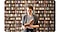 1. A woman reading a book standing in front of a bookcase full of books. The bookcase in the background in blurred out.