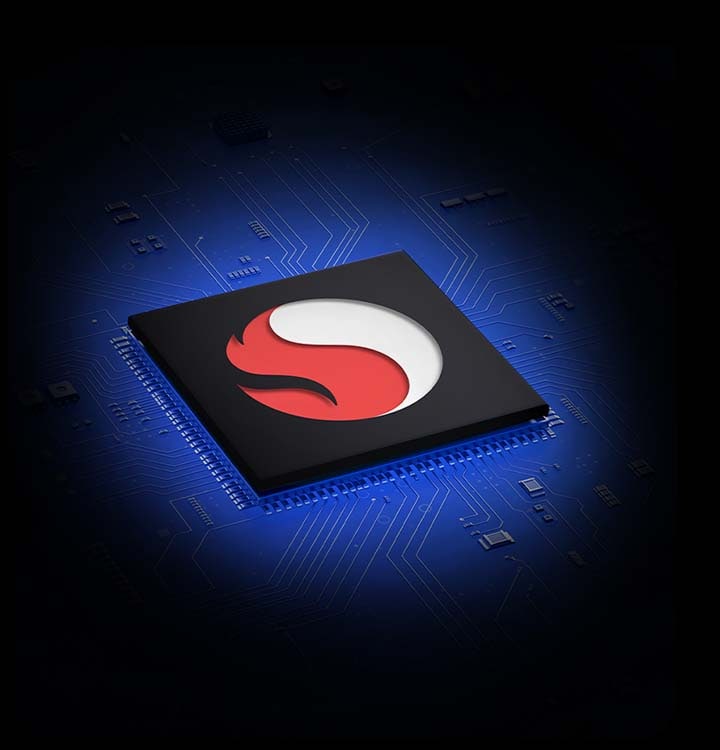 A black processing chipset is surrounded by a blue background with complex circuitry. The Snapdragon logo is in the center of the chip.