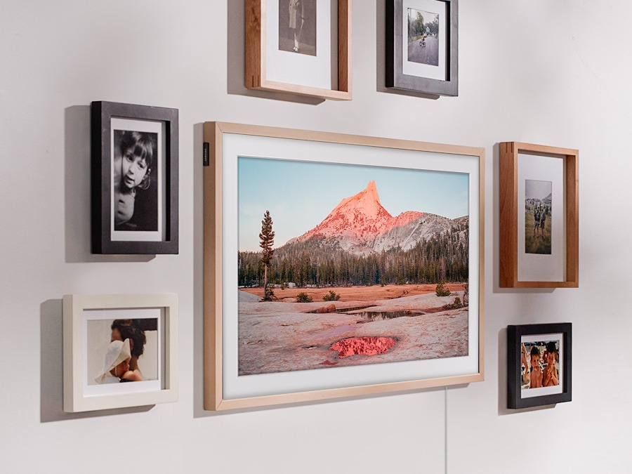 The Frame is hanging on a wall via a Slim Fit Wall Mount to look like a real picture frame.