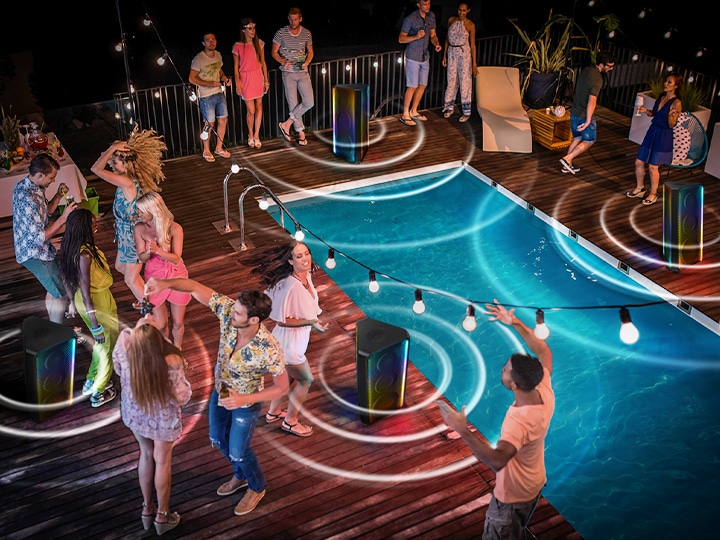 4 Sound Towers are placed in the midst of a pool party with many people.