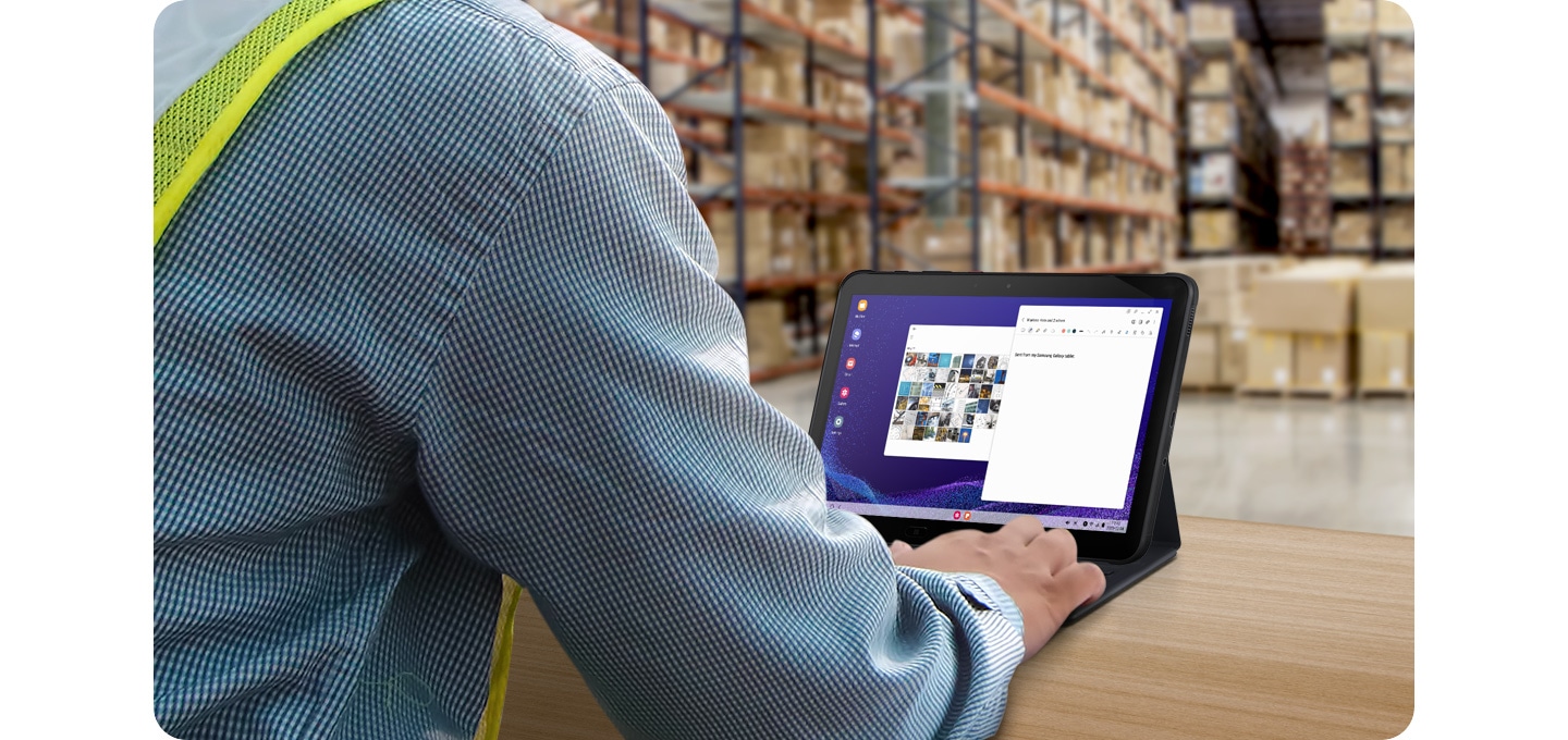 Warehouse worker using Galaxy Tab Active4 Pro with attached Book Cover Keyboard in DeX mode