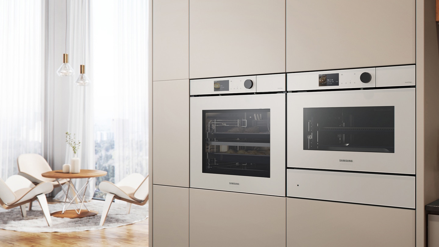 Shows the built-in oven installed in a kitchen, with two cooking zones and a hinged door, next to a Microwave Combi oven.