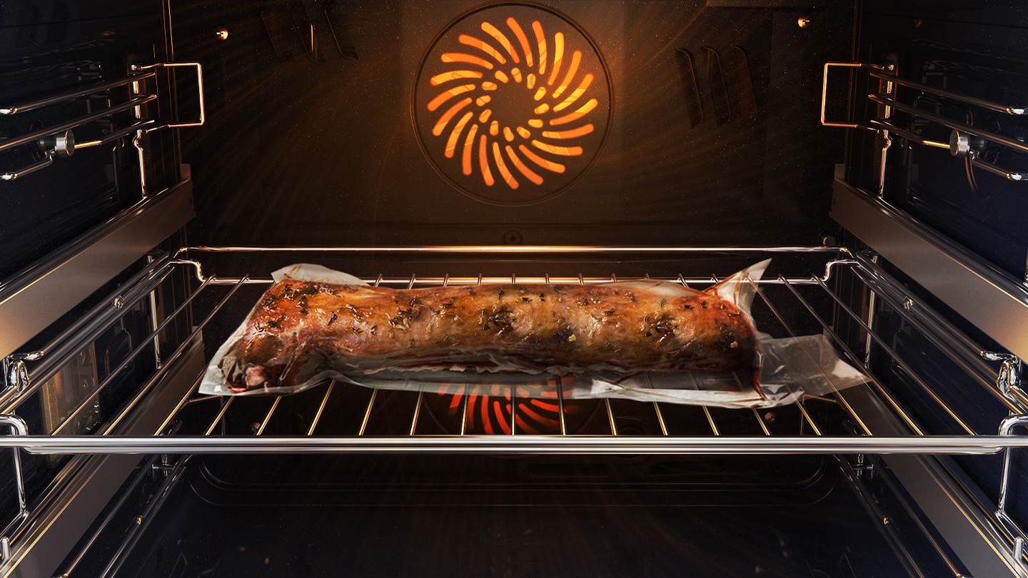 Shows a joint of meat inside the oven, which is tightly sealed in a plastic bag and on a metal tray, being cooked using the Air Sous Vide system.