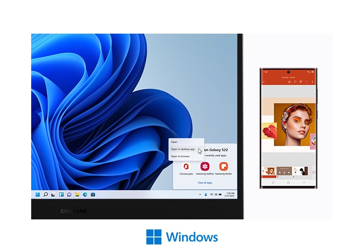 A Galaxy Book2 Go and a Galaxy S22 Ultra are next to each other. On the PC screen, there is a blue wavy wallpaper with a Recent Apps window from mobile in the bottom right corner. Recent Apps are PowerPoint, Samsung Gallery and Samsung Notes. A mouse cursor is on the Open in desktop app button on the PC screen. On a Galaxy S22 Ultra to the right, Microsoft PowerPoint is open with a slide that has color swatches as well as a face of a woman with colorful make up on. Below, there is a Microsoft Windows logo.