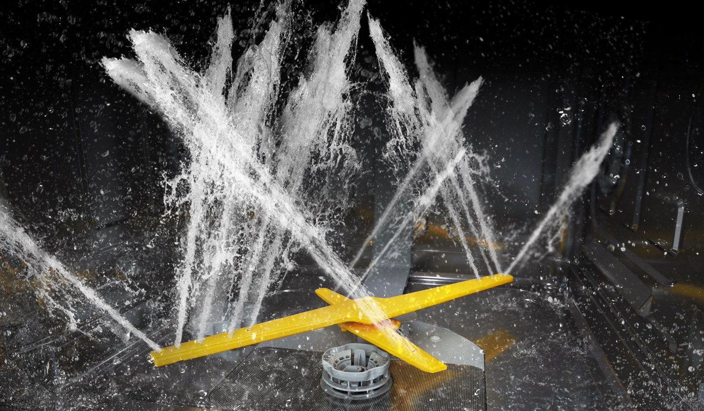 Shows the rotating dual wash arms of the WaterJet Clean™ system spraying powerful jets of water in multiple directions.