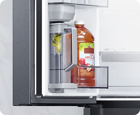 The fridge door is open to show the Autofill Water Pitcher filling with water, and with lemons in the built-in infuser.