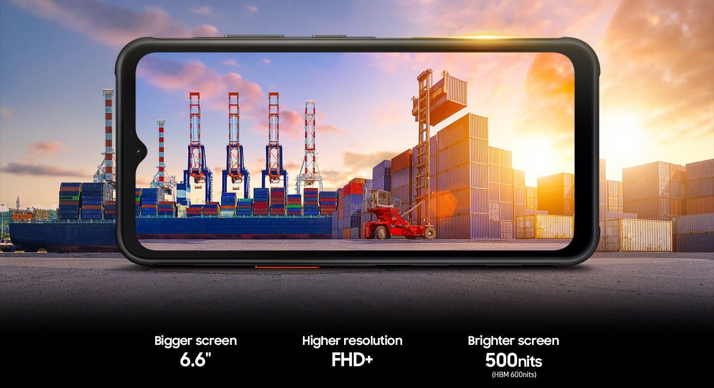 A stack of containers being loaded onto a vessel at a port, viewed from a Galaxy XCover7 display extending into the background. Bigger screen 6.6". Higher resolution FHD+. Brighter screen 500nits or HBM 600nits.