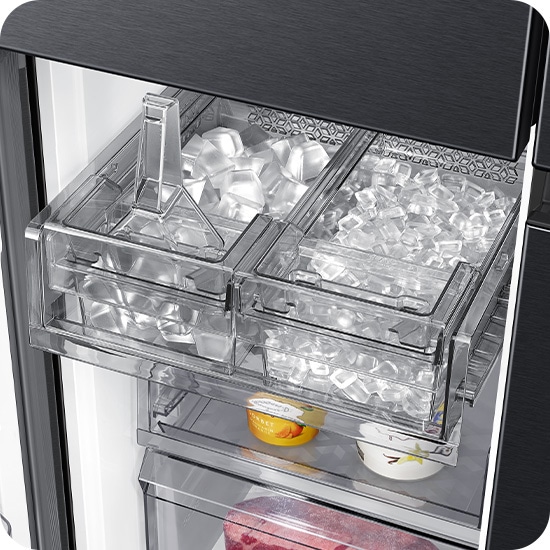 The dual tray in the freezer has ice. The left tray is full of cubed ice and the right tray has ice bites.