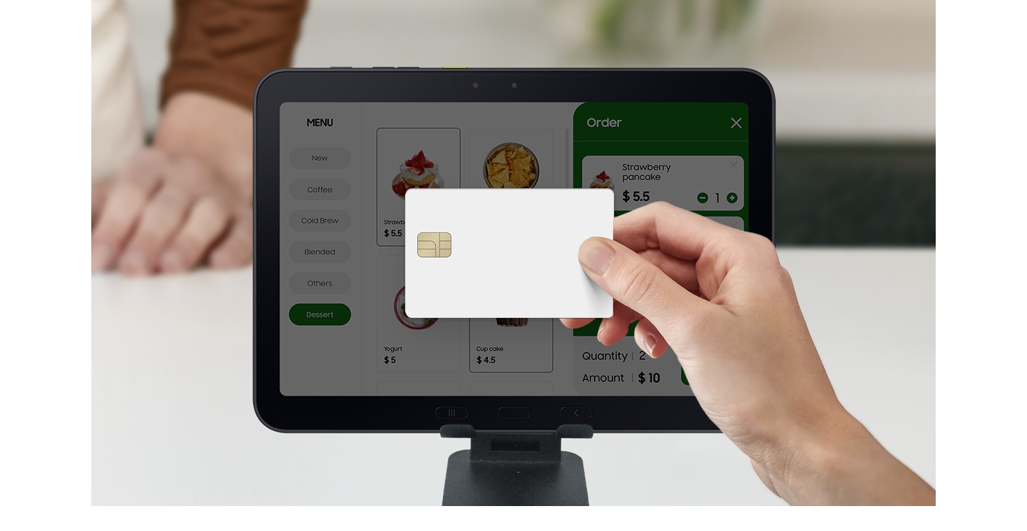 A hand holds a credit card near the Galaxy Tab Active5 Pro screen to make a payment at a restaurant. Galaxy Tab Active5 Pro is used to display the menu, take orders and process payments.