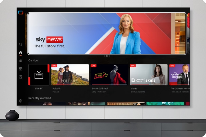 TV in a living room shows Samsung TV Plus home screen and the diverse TV channels available with it.