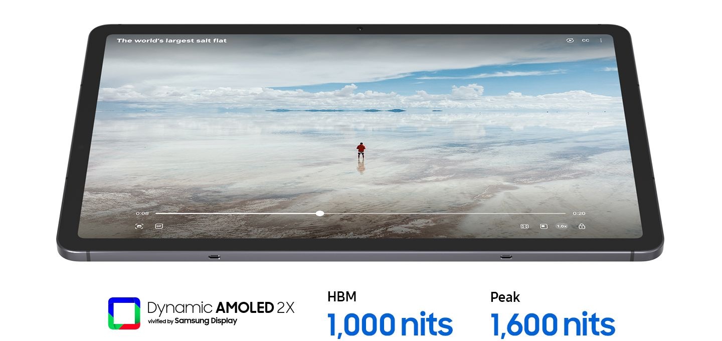 A Galaxy Tab S11 device playing a video of a person in a vast, bright landscape on its large display, showcasing ultra-clear visibility. Text below reads Dynamic AMOLED 2X vivified by Samsung Display, HBM 1000 nits, Peak 1600 nits.