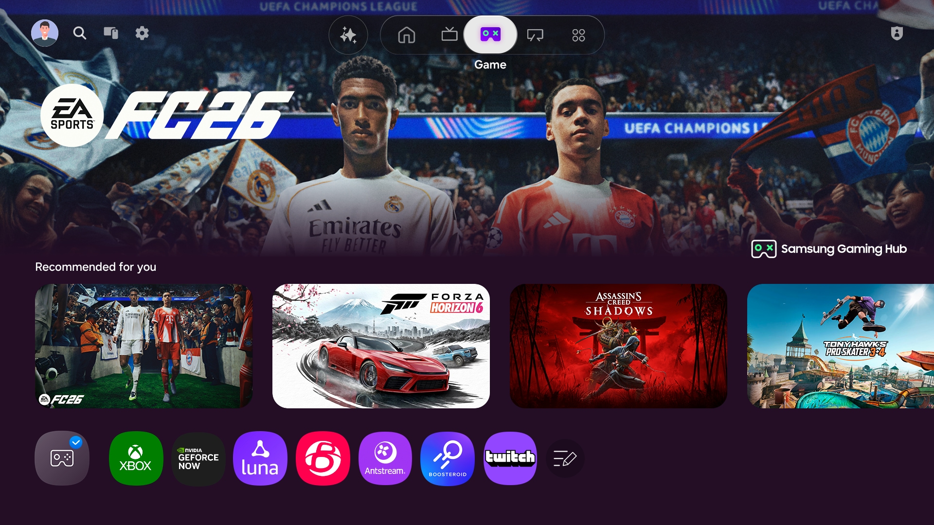 На телевізорі відображається головний екран Samsung Gaming Hub, на якому є можливості потокової передачі та ігор.