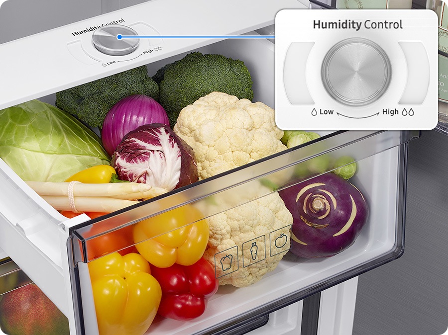 The vegetable box is filled with fresh vegetables. A close-up of the humidity control on the vegetable box. The arrow pointing to Low on the left has one water droplet icon, while the arrow pointing to High on the right has two water droplet icons.